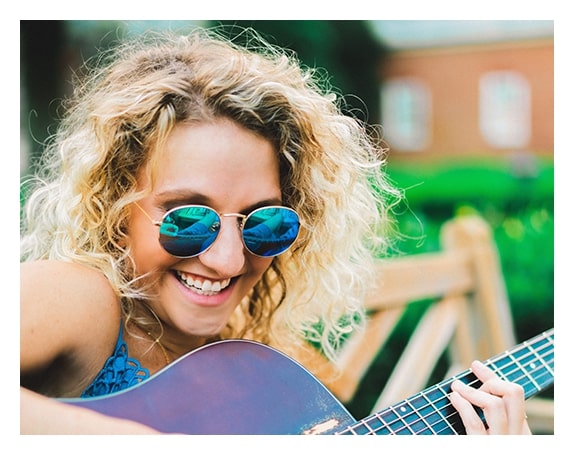 Happy Woman wearing her sunglasses