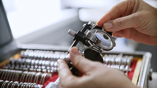 Eye doctor customizing lens in a lab at Dietz McLean Optical