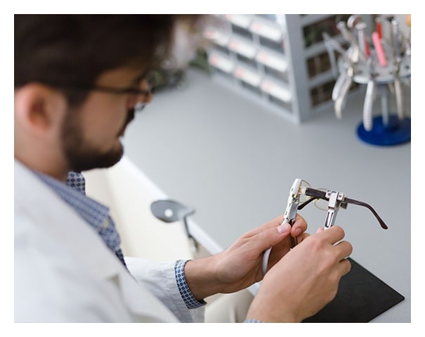 Optician repairing eyeglasses in San Antonio Texas