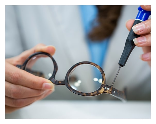 Optician fixing broken glasses frames at Dietz McLean Optical
