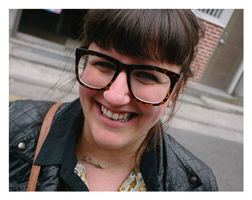 Woman smiling wearing Dietz-McLean Optical specialty fit plus sized glasses